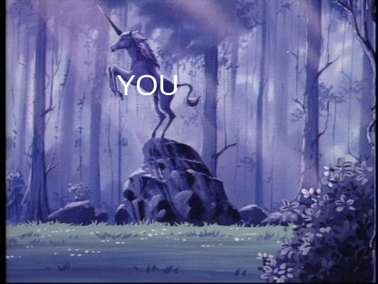 A unicorn rearing up on top of a boulder in an enchanted forest. It is labelled "you"